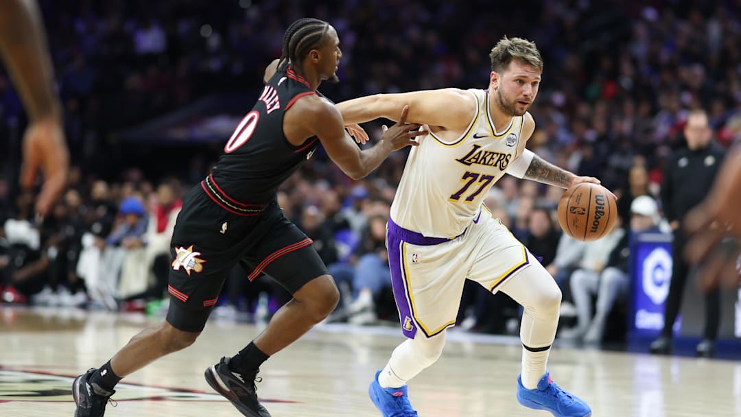 Dec 7, 2025; Philadelphia, Pennsylvania, USA; Los Angeles Lakers guard Luka Doncic (77) dribbles past Philadelphia 76ers guard Tyrese Maxey during the second quarter at Xfinity Mobile Arena. Mandatory Credit: Bill Streicher-Imagn Images