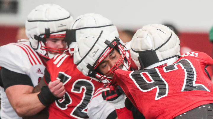 The Louisville offensive and defensive line during practice 