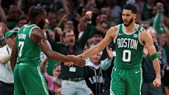 Boston Celtics forward Jayson Tatum (0) celebrates with guard Jaylen Brown.