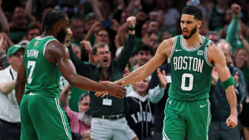 Boston Celtics forward Jayson Tatum (0) celebrates with guard Jaylen Brown.