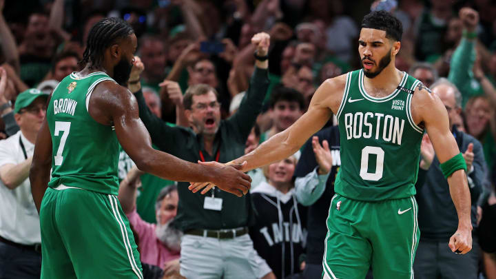 Boston Celtics forward Jayson Tatum (0) celebrates with guard Jaylen Brown.