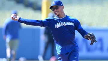 Aug 5, 2024; Los Angeles, California, USA;  Los Angeles Dodgers second baseman Mookie Betts (50) fields ground balls prior to the game against the Philadelphia Phillies at Dodger Stadium. Dodger players wore #MaxStrong shirts during pregame to honor Max, the 3-year old son of first baseman Freddie Freeman (5), who was diagnosed with Guillian-Barre syndrome. Mandatory Credit: Jayne Kamin-Oncea-USA TODAY Sports