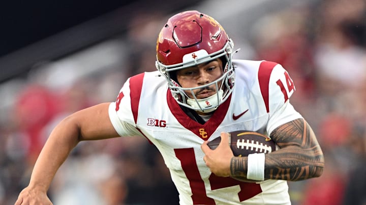 Sep 13, 2025; West Lafayette, Indiana, USA; USC Trojans quarterback Jayden Maiava (14) is tackled by Purdue Boilermakers defensive back Hudauri Hines (4) during the second quarter at Ross-Ade Stadium. Mandatory Credit: Marc Lebryk-Imagn Images Sep 13, 2025; West Lafayette, Indiana, USA; USC Trojans quarterback Jayden Maiava (14) is tackled by Purdue Boilermakers defensive back Hudauri Hines (4) during the second quarter at Ross-Ade Stadium. Mandatory Credit: Marc Lebryk-Imagn Images