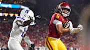 Nov 7, 2025; Los Angeles, California, USA; Southern California Trojans wide receiver Makai Lemon (6) scores a touchdown against Northwestern Wildcats defensive back Josh Fussell (13) during the first half at the Los Angeles Memorial Coliseum. Mandatory Credit: Gary A. Vasquez-Imagn Images