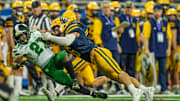 Hudsonville’s Connor Brintnall tackles Detroit Cass Tech RB Jaylen Spates during the 2024 MHSAA Division 1 football finals. Hudsonville hosts Byron Center Thursday night to kick off the 2025 Michigan high school football season. 