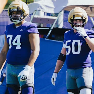Drew Azzopardi (74), Carver Willis (50) and Elishah Jackett (76) wait for the next UW spring drill. 