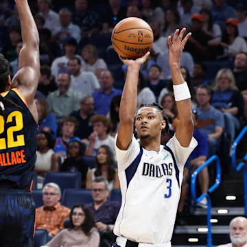 Apr 14, 2024; Oklahoma City, Oklahoma, USA; Dallas Mavericks forward Alex Fudge (3) shoots as Oklahoma City Thunder guard Cason Wallace (22) defends during the second quarter at Paycom Center. Mandatory Credit: Alonzo Adams-Imagn Images