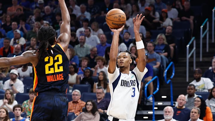 Apr 14, 2024; Oklahoma City, Oklahoma, USA; Dallas Mavericks forward Alex Fudge (3) shoots as Oklahoma City Thunder guard Cason Wallace (22) defends during the second quarter at Paycom Center. Mandatory Credit: Alonzo Adams-Imagn Images