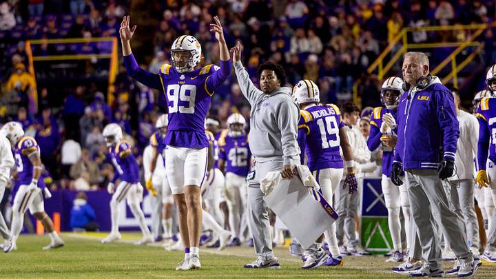 Nov 30, 2024; Baton Rouge, Louisiana, USA;  LSU Tigers defensive tackle Gio Paez (99) and head coach Brian Kelly react to a field goal made against the Oklahoma Sooners during the fourth quarter at Tiger Stadium. Mandatory Credit: Stephen Lew-Imagn Images