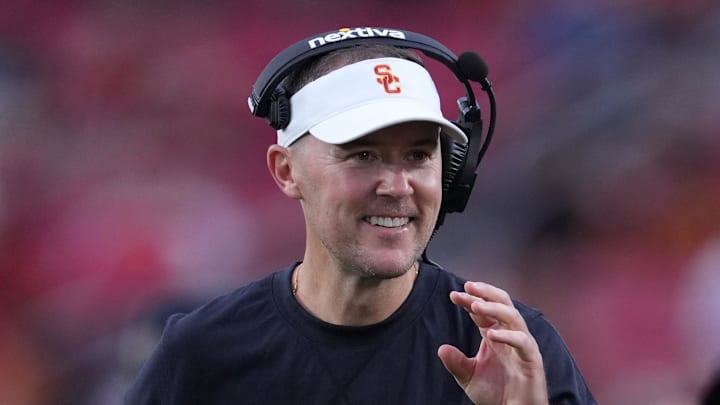 Sep 2, 2023; Los Angeles, California, USA; Southern California Trojans head coach Lincoln Riley (leff) and wide receivers coach Dennis Simmons react against the Nevada Wolf Pack in the second half at United Airlines Field at Los Angeles Memorial Coliseum. Mandatory Credit: Kirby Lee-Imagn Images Sep 2, 2023; Los Angeles, California, USA; Southern California Trojans head coach Lincoln Riley (leff) and wide receivers coach Dennis Simmons react against the Nevada Wolf Pack in the second half at United Airlines Field at Los Angeles Memorial Coliseum. Mandatory Credit: Kirby Lee-Imagn Images