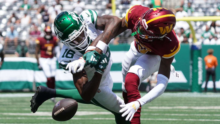 Washington Commanders cornerback Emmanuel Forbes, right, breaks up a pass to New York Jets wide receiver Mike Williams during the first quarter at MetLife Stadium. 