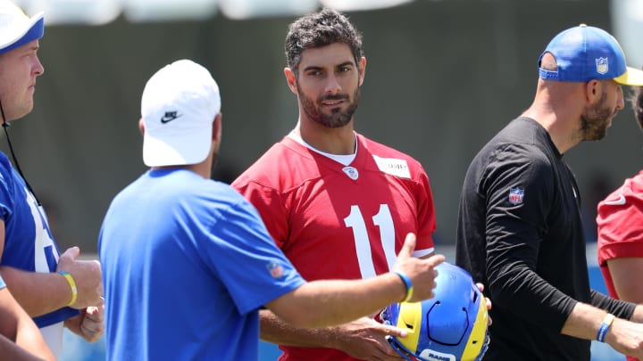 Jul 31, 2024; Los Angeles, CA, USA;  Los Angeles Rams quarterback Jimmy Garoppolo (11) talks with a member of the coaching staff during training camp at Loyola Marymount University. Mandatory Credit: Kiyoshi Mio-USA TODAY Sports