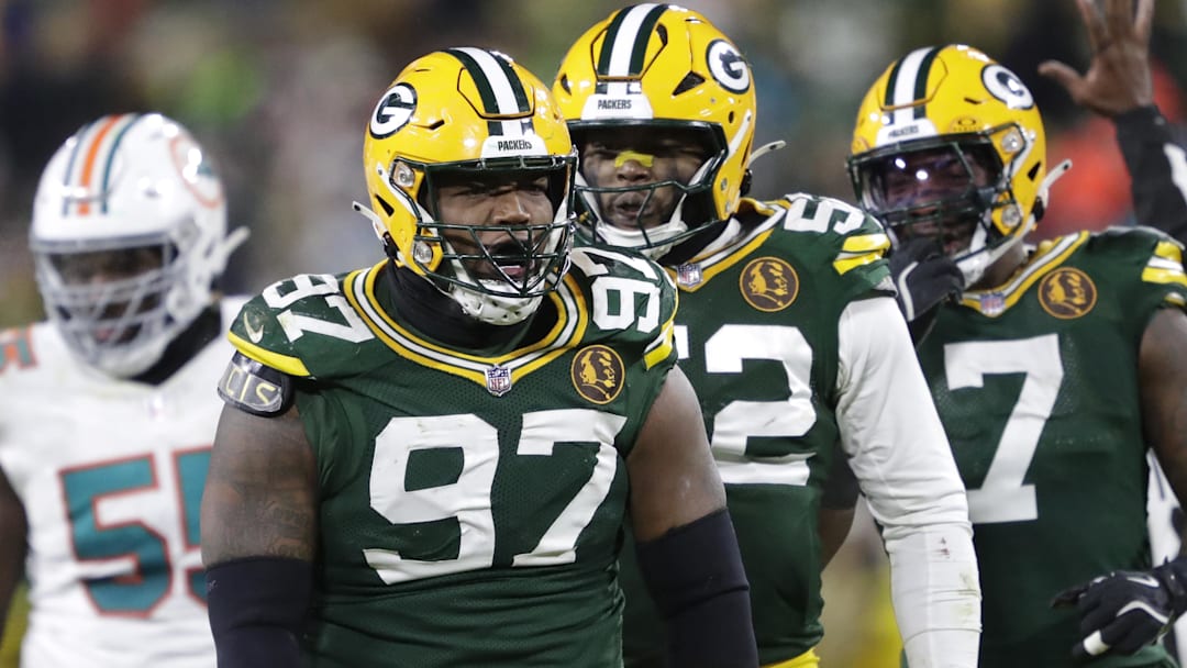 Green Bay Packers DT Kenny Clark celebrates sacking Miami Dolphins QB Tua Tagovailoa with EDGE Rashan Gary.