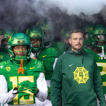Oregon head coach Dan Lanning, center, waits to take the field with his team for their game against Oregon State at Autzen Stadium Friday, Nov. 24, 2023.