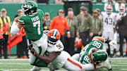 Nov 9, 2025; East Rutherford, New Jersey, USA;  New York Jets quarterback Justin Fields (7) is tackled by Cleveland Browns defensive tackle Maliek Collins (96) at MetLife Stadium. Mandatory Credit: Vincent Carchietta-Imagn Images