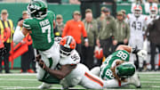 Nov 9, 2025; East Rutherford, New Jersey, USA;  New York Jets quarterback Justin Fields (7) is tackled by Cleveland Browns defensive tackle Maliek Collins (96) at MetLife Stadium. Mandatory Credit: Vincent Carchietta-Imagn Images