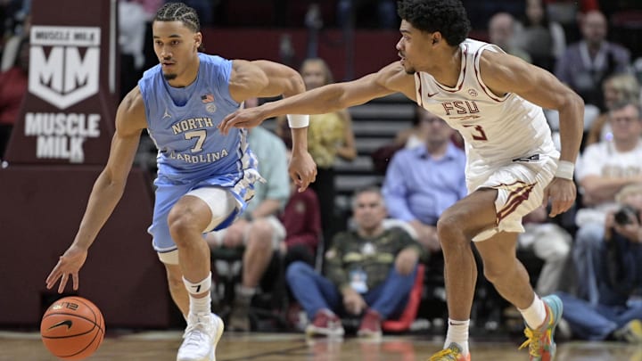 Feb 24, 2025; Tallahassee, Florida, USA; North Carolina Tarheels guard Seth Trimble (7) drives the ball up the court past Florida State Seminoles guard Bostyn Holt (3) during the second half at Donald L. Tucker Center. Mandatory Credit: Melina Myers-Imagn Images