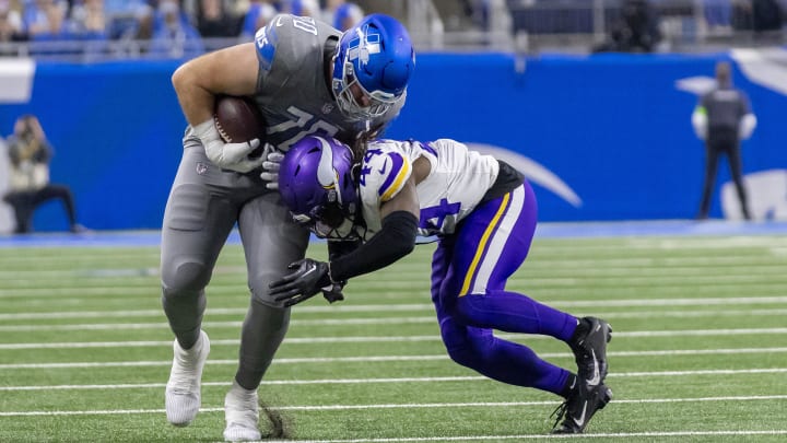 Jan 7, 2024; Detroit, Michigan, USA; Detroit Lions offensive tackle Dan Skipper (70) catches a pass after checking in and is tackled by Minnesota Vikings safety Josh Metellus (44) during second half at Ford Field. Mandatory Credit: David Reginek-USA TODAY Sports