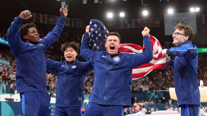 From left to right, Frederick Richard, Asher Hong, Brody Malone and Stephen Nedoroscik celebrate after winning bronze during the men’s team final.