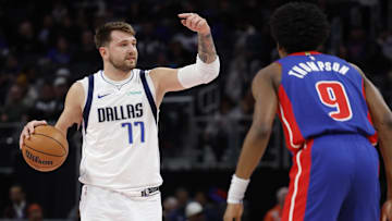 Mar 9, 2024; Detroit, Michigan, USA;  Dallas Mavericks guard Luka Doncic (77) dribbles against Detroit Pistons forward Ausar Thompson (9): Rick Osentoski-Imagn Images