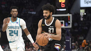 Dec 7, 2025; Charlotte, North Carolina, USA; Denver Nuggets guard Jamal Murray (27) drives in past Charlotte Hornets guard Brandon Miller (24) during the second half at the Spectrum Center. Mandatory Credit: Sam Sharpe-Imagn Images