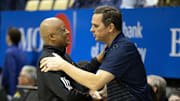 Jan 25, 2025; Berkeley, California, USA; Miami Hurricanes interim head coach Bill Courtney (left) greets California Golden Bears head coach Mark Madsen before their game at Haas Pavilion. Mandatory Credit: D. Ross Cameron-Imagn Images