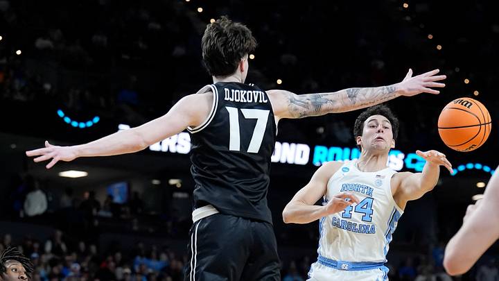 Mar 19, 2026; Greenville, SC, USA; North Carolina Tar Heels guard Luka Bogavac (44) passes the ball around VCU Rams forward Lazar Djokovic (17) in the first half of a first round game of the men's 2026 NCAA Tournament at Bon Secours Wellness Arena. Mandatory Credit: Jim Dedmon-Imagn Images