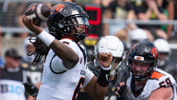 Oregon State quarterback Maalik Murphy, left, throws downfield against Oregon pressure during the second quarter.