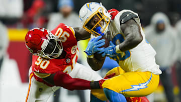 Dec 8, 2024; Kansas City, Missouri, USA; Los Angeles Chargers running back Kimani Vidal (30) is tackled by Kansas City Chiefs defensive end Charles Omenihu (90) during the second half at GEHA Field at Arrowhead Stadium. Mandatory Credit: Jay Biggerstaff-Imagn Images