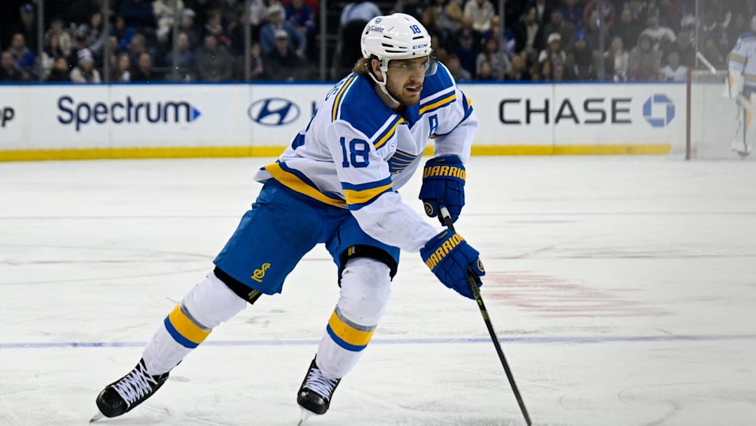Nov 24, 2025; New York, New York, USA; St. Louis Blues center Robert Thomas (18) skates with the puck against the New York Rangers during the third period at Madison Square Garden. Mandatory Credit: Dennis Schneidler-Imagn Images