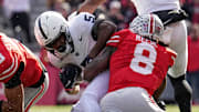 Ohio State Buckeyes linebacker Arvell Reese (8) hits Penn State Nittany Lions wide receiver Devonte Ross (5) beside cornerback Lorenzo Styles Jr. (3) during the NCAA football game at Ohio Stadium in Columbus on Nov. 1, 2025.