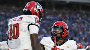 Sep 20, 2025; Durham, North Carolina, USA;  North Carolina State Wolfpack running back Darius Johnson (25) celebrates North Carolina State Wolfpack quarterback Will Wilson's (10) touchdown in the fourth quarter against the Duke Blue Devils at Wallace Wade Stadium. Mandatory Credit: Zachary Taft-Imagn Images