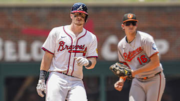 Jul 6, 2025; Cumberland, Georgia, USA; Atlanta Braves catcher Sean Murphy (12) arrives at second base in front of Baltimore Orioles first baseman Coby Mayo (16) after hitting a double during the seventh inning at Truist Park. Mandatory Credit: Dale Zanine-Imagn Images
