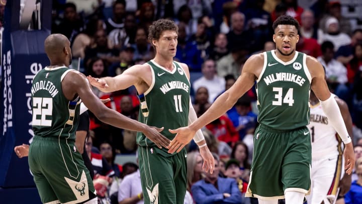 Mar 28, 2024; New Orleans, Louisiana, USA;  Milwaukee Bucks forward Giannis Antetokounmpo (34) slaps hands with forward Khris Middleton (22) and center Brook Lopez (11) after a play against the New Orleans Pelicans during the second half at Smoothie King Center. Mandatory Credit: Stephen Lew-USA TODAY Sports