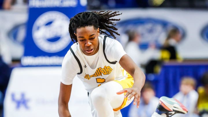 Woodford County point guard Jasper Johnson battles Warren Central guard Damarion Walkup for control of the ball in the second half of Saturday's KHSAA Boys Sweet 16 semifinal. The Yellowjackets fell to the Dragons 56-48. March 18, 2023