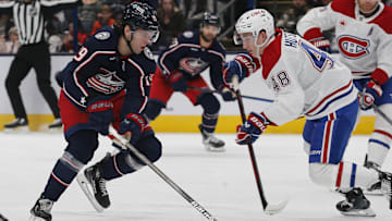 Dec 23, 2024; Columbus, Ohio, USA; Columbus Blue Jackets center Adam Fantilli (19) chases after a loose puck as Montreal Canadiens defenseman Lane Hutson (48) defends during the second period at Nationwide Arena. Mandatory Credit: Russell LaBounty-Imagn Images