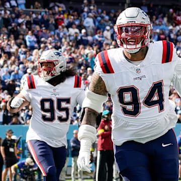 New England Patriots defensive tackle Cory Durden (94) celebrates after linebacker K'Lavon Chaisson (44) ran in a Tennessee Titans fumble during the third quarter at Nissan Stadium in Nashville, Tenn., Sunday, Oct. 19, 2025.
