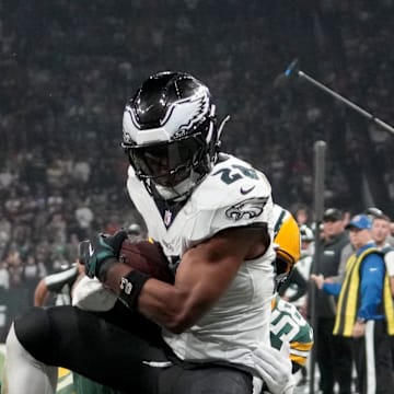 Sep 6, 2024; Sao Paulo, BRA; Philadelphia Eagles running back Saquon Barkley (26) catches a touchdown against Green Bay Packers linebacker Isaiah McDuffie (58) and safety Xavier McKinney (29) during the second quarter at Neo Quimica Arena. Mandatory Credit: Kirby Lee-Imagn Images