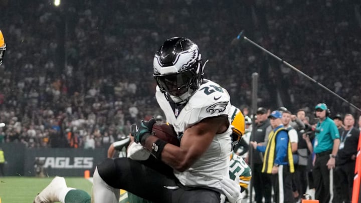 Sep 6, 2024; Sao Paulo, BRA; Philadelphia Eagles running back Saquon Barkley (26) catches a touchdown against Green Bay Packers linebacker Isaiah McDuffie (58) and safety Xavier McKinney (29) during the second quarter at Neo Quimica Arena. Mandatory Credit: Kirby Lee-Imagn Images