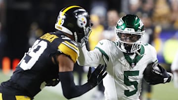New York Jets wide receiver Garrett Wilson (5) runs after a catch as Pittsburgh Steelers safety Minkah Fitzpatrick (39) defends during the first quarter at Acrisure Stadium.