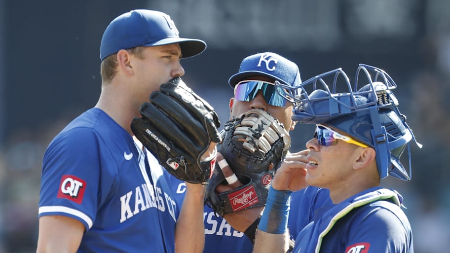 Salvador Perez, center, in a mound meeting as a first baseman