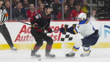 Feb 21, 2023; Raleigh, North Carolina, USA; Carolina Hurricanes center Martin Necas (88) holds onto the puck against St. Louis Blues defenseman Nick Leddy (4) during the second period at PNC Arena. Mandatory Credit: James Guillory-USA TODAY Sports