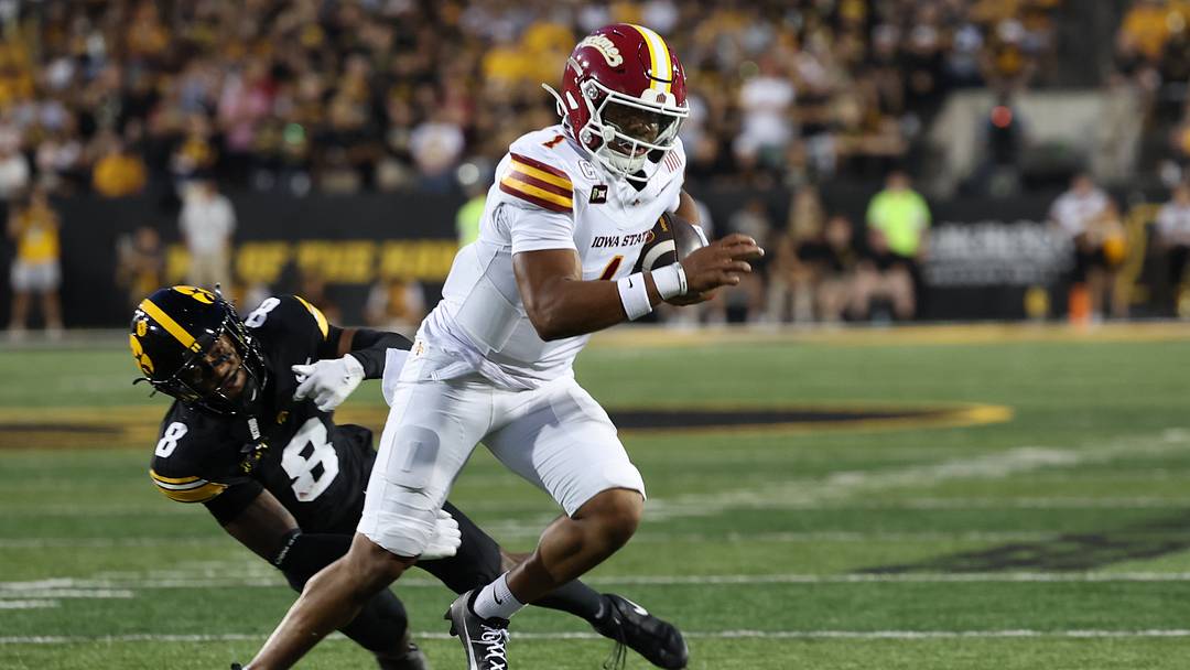 Sep 12, 2026; Iowa City, Iowa, USA;  Iowa State Cyclones quarterback Jaylen Raynor (1) carries the ball as Iowa Hawkeyes defensive back Deshaun Lee (8) defends during the second quarter at Kinnick Stadium.  Mandatory Credit: Reese Strickland-Imagn Images