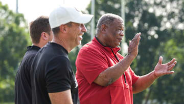 Vince Marrow, UofL's new executive director of player personnel and recruiting, at a recent Louisville football practice. Marrow left Kentucky after serving as assistant coach under head coach Mark Stoops. In the foreground is UofL football's chief of staff Greg Brohm. July 30, 2025.