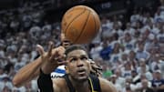 May 6, 2025; Minneapolis, Minnesota, USA; Golden State Warriors center Kevon Looney (5) tries for a rebound in front of Minnesota Timberwolves center Rudy Gobert (27) in the fourth quarter during game one of the second round for the 2025 NBA Playoffs at Target Center. Mandatory Credit: Bruce Kluckhohn-Imagn Images