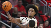 Jan 18, 2025; Louisville, Kentucky, USA; Louisville Cardinals guard Chucky Hepburn (24) looks to pass over Virginia Cavaliers guard Ishan Sharma (9) during the second half at KFC Yum! Center. Louisville defeated Virginia 81-67. Mandatory Credit: Jamie Rhodes-Imagn Images