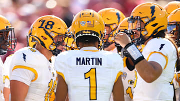 Oct 4, 2025; Norman, Oklahoma, USA;  Kent State Golden Flashes quarterback Devin Kargman (15) huddles with his team during the first half against the Oklahoma Sooners at Gaylord Family-Oklahoma Memorial Stadium. Mandatory Credit: Kevin Jairaj-Imagn Images