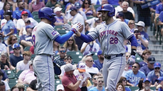 New York Mets designated hitter J.D. Martinez is greeted by  outfielder Brandon Nimmo after hitting a home run.