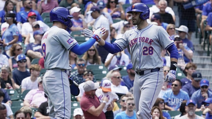 Jun 21, 2024; Chicago, Illinois, USA; New York Mets designated hitter J.D. Martinez (28) is greeted by  outfielder Brandon Nimmo (9) after hitting a three-run home run against the Chicago Cubs during the first inning at Wrigley Field. Mandatory Credit: David Banks-USA TODAY Sports