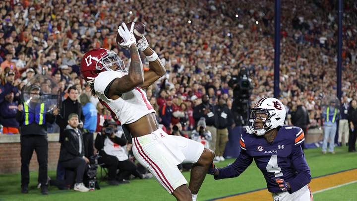 Nov 25, 2023; Auburn, Alabama, USA;  Alabama Crimson Tide wide receiver Isaiah Bond (17) scores the game winning touchdown over Auburn Tigers cornerback D.J. James (4) during the fourth quarter at Jordan-Hare Stadium. Mandatory Credit: John Reed-Imagn Images